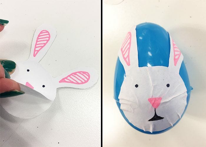 Bunny face label peeled off and stuck onto blue plastic Easter egg