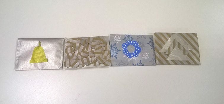 Completed DIY Gift Card Holder Envelopes row of silver foil gift card envelopes with various designs