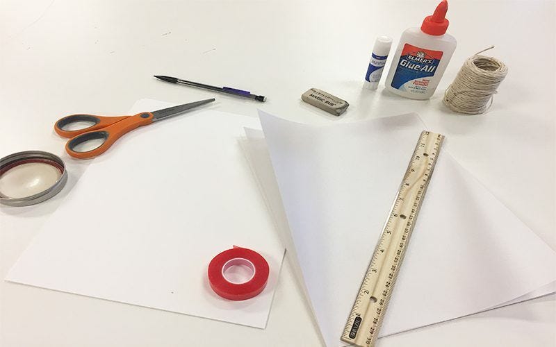 Art supplies for paper cathedral lantern: paper, tape, ruler, scissors, pencil, eraser, twine, glue