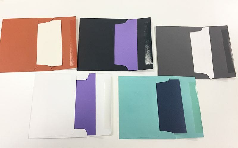 Assorted colored envelopes on a white background