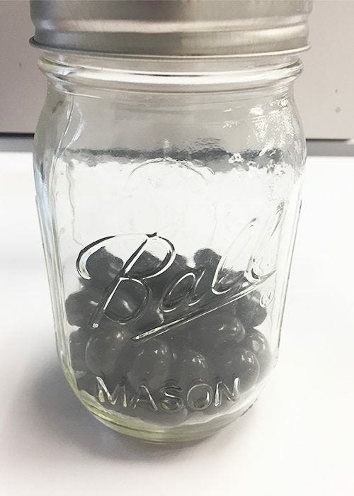 JAM's Official List of 10 Desk Essentials, glass jar, snacks, desk, coffee beans