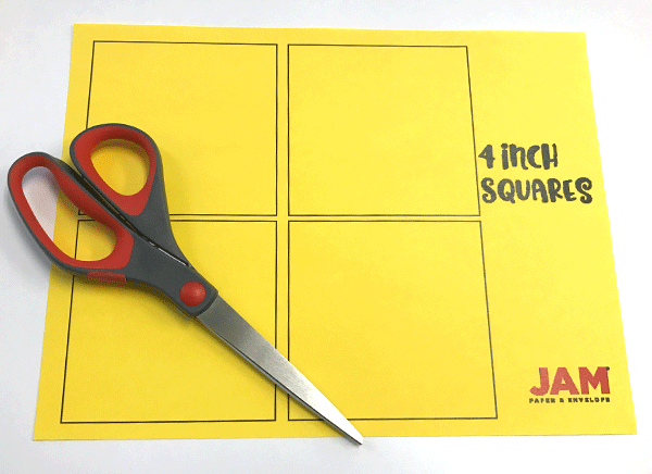 Yellow paper with 4.5 inch squares, scissors