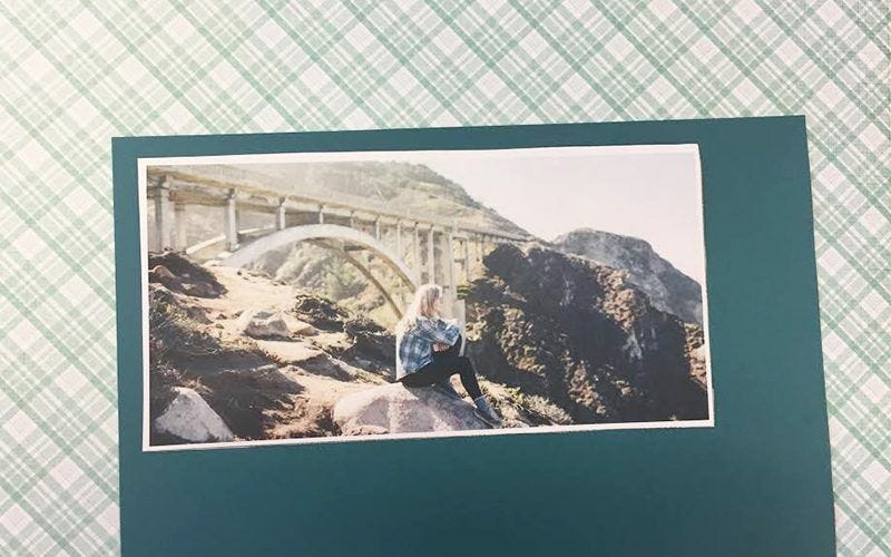 Photo of woman sitting near bridge