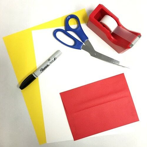 materials for DIY movie popcorn invitation popcorn invite materials - yellow colored paper, white paper, black sharpie, scissors, tape, red envelope