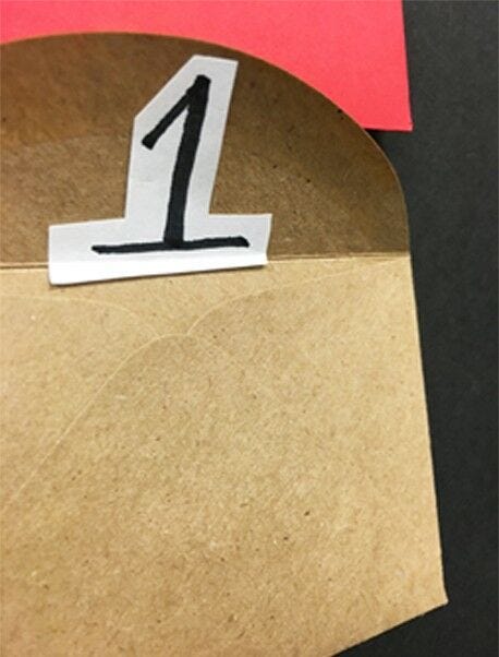 brown kraft envelope with black and white number one attached