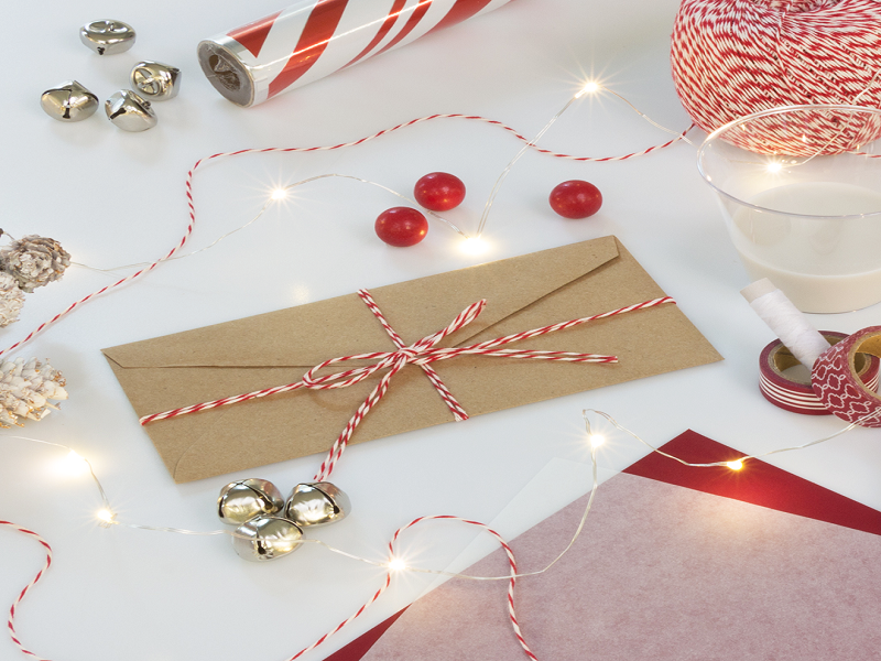 brown kraft envelope holiday stationery and gift wrap with jingle bells and twinkle lights