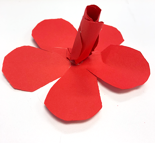 red paper rose cutout with rolled paper bud glued to center