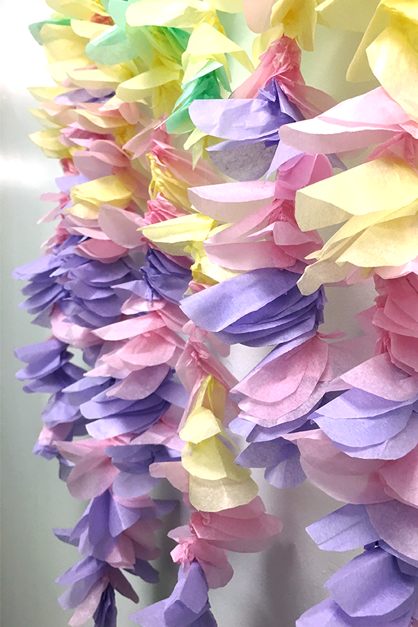 yellow purple green and pink tissue paper flower garland closeup