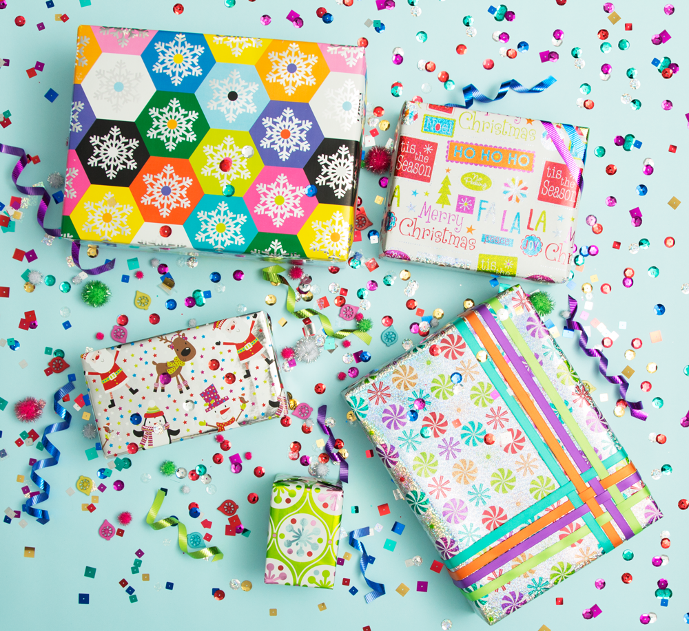 holiday wrapping trend 2: 5 multicolored wrapped holiday presents with rainbow confetti