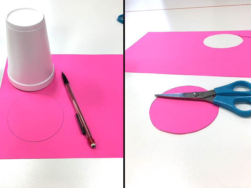 circle traced on hot pink paper with white cup and cut out with scissors