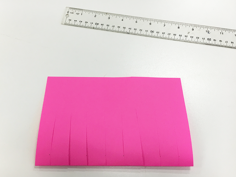 Pink paper cut, ruler, paper