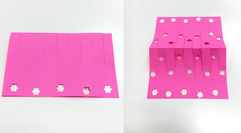 Pink paper flower shapes hole punched Pink paper with flower shapes hole punched