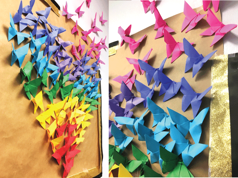 Paper butterflies arranged into a heart on the wall