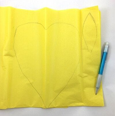 heart and flower petal shape traced on yellow tissue 