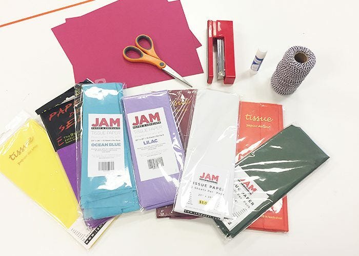 Art supplies for paper fans: Paper, tissue, scissors, stapler, glue stick, twine