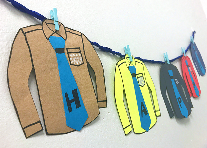 diy father's day banner paper shirts pinned on blue ribbon