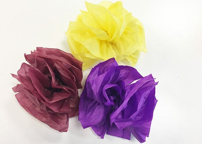 Completed yellow, burgundy, and purple pompom flowers