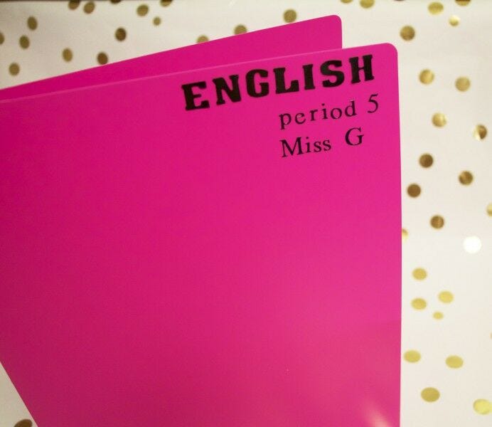 personalize school supplies: black letter stickers attached to neon pink folder