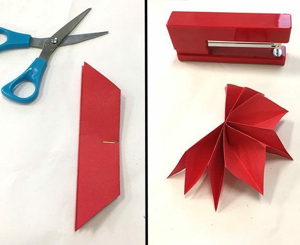 scissors, red paper folded, red stapler