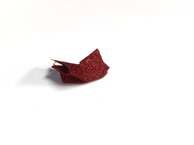 small piece of crumpled red glitter wrapping paper 