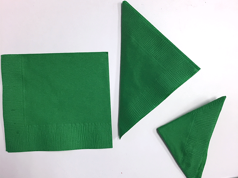 green paper napkins folded into big triangles