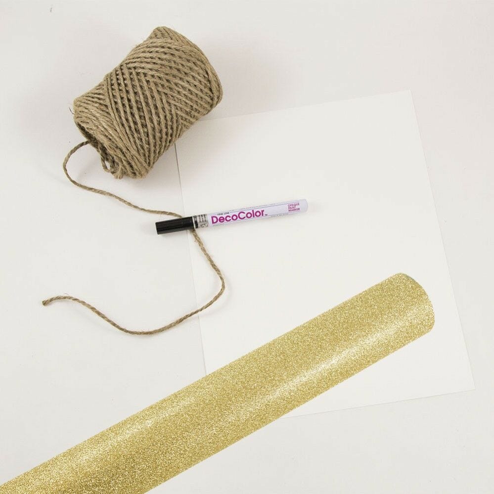 White paper, gold glitter wrapping paper, twine