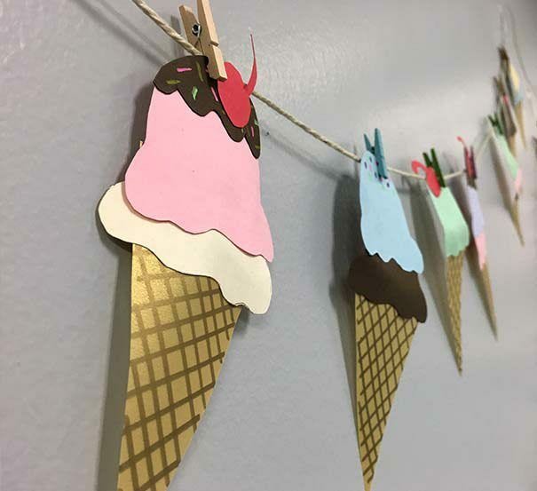 paper ice cream drawings clipped to twine with clothespins