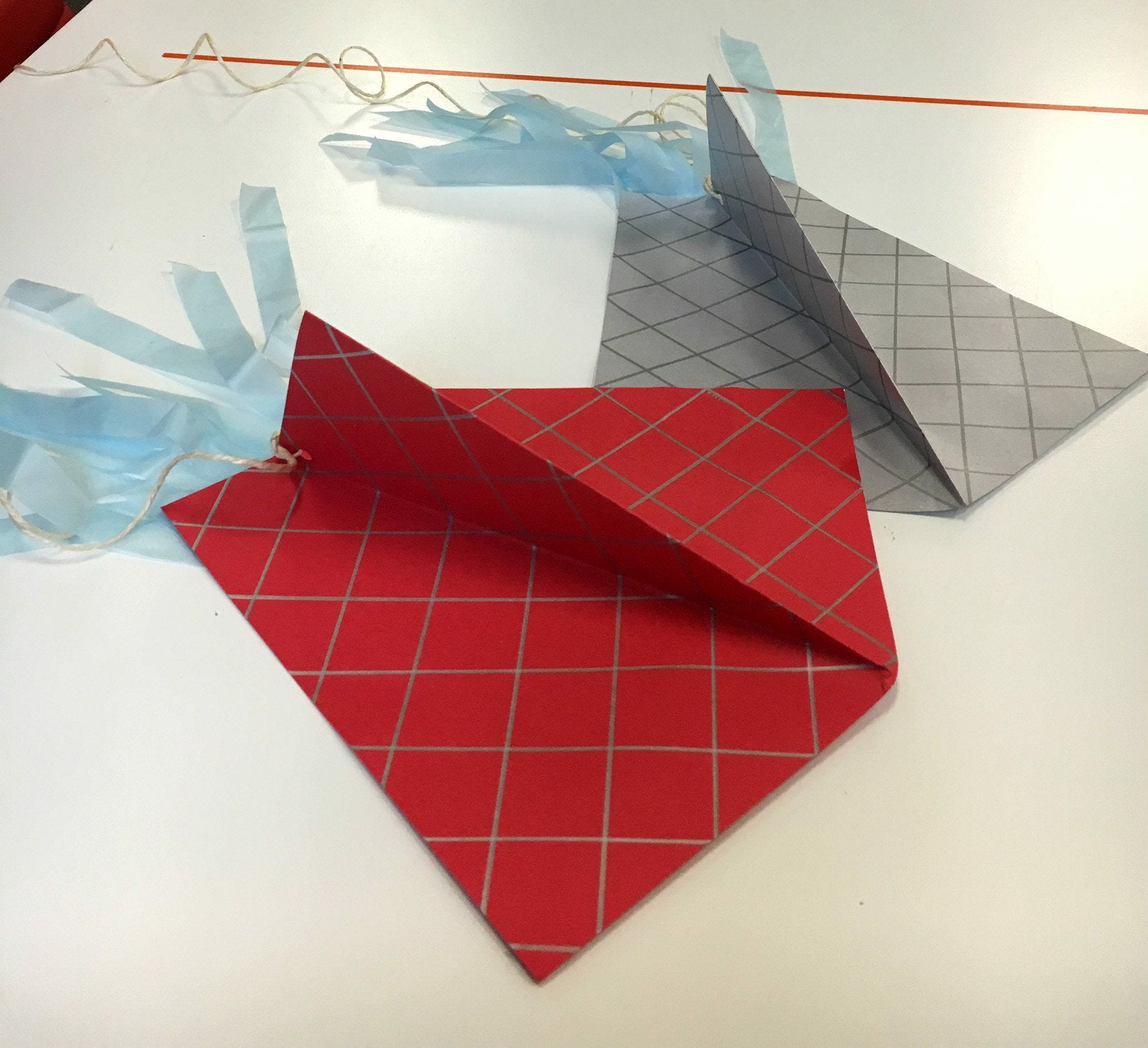 red and gray grid diy paper kites with blue streamers