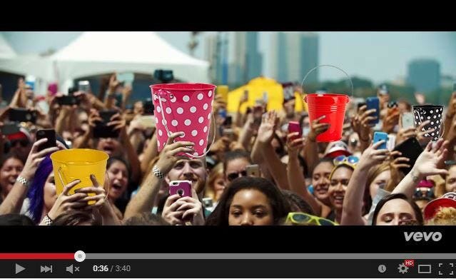 youtube video screenshot people in crowd holding JAM metal buckets