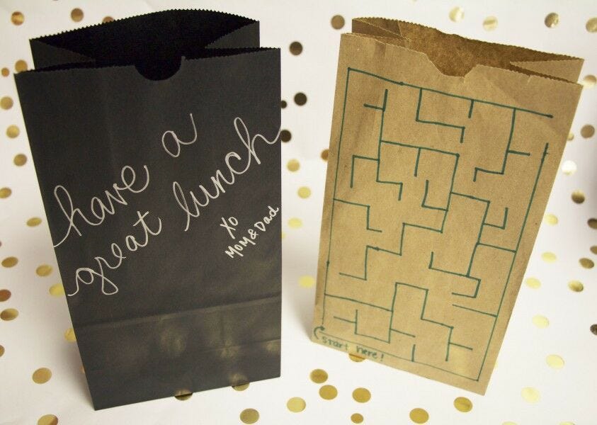 black and brown decorated paper bags standing up 