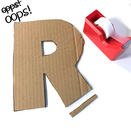 brown cardboard letter r with red tape dispenser