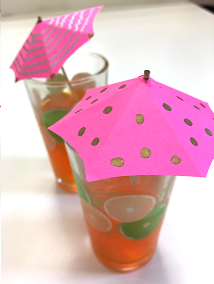 decorated pink drink umbrellas in glass cups