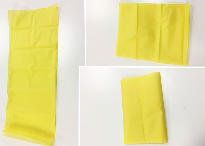 Yellow tissue paper folded in half