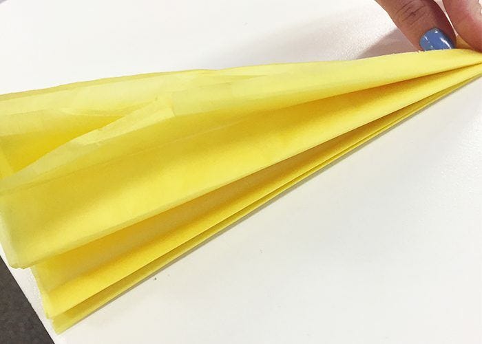 Accordion folds in yellow tissue paper