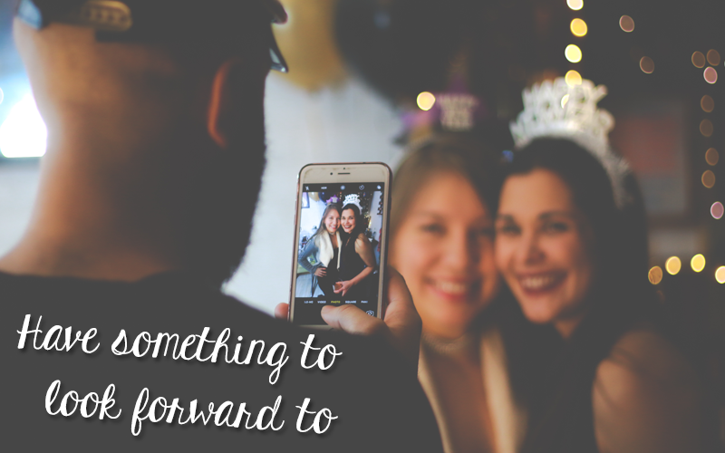 "Have something to look forward to" - Man taking picture of two friends at a party Guy taking picture two friends at a party, caption "Have something to look forward to"