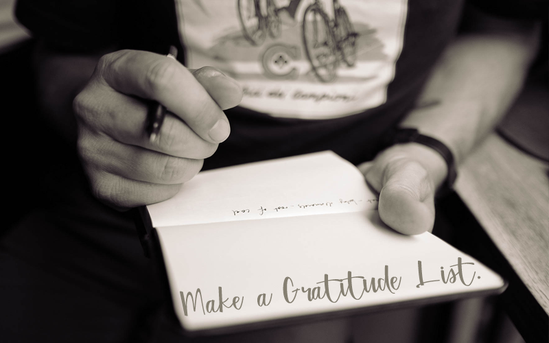 "Make a gratitude list" - person with pen and paper in hand creating a list Person with pen and paper in hand, caption "Make a gratitude list"