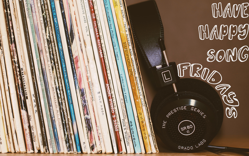 Stack of records and a pair of headphones on a shelf with caption "Have Happy Song Fridays"