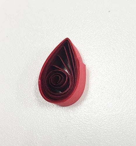 Red paper spiral quilled