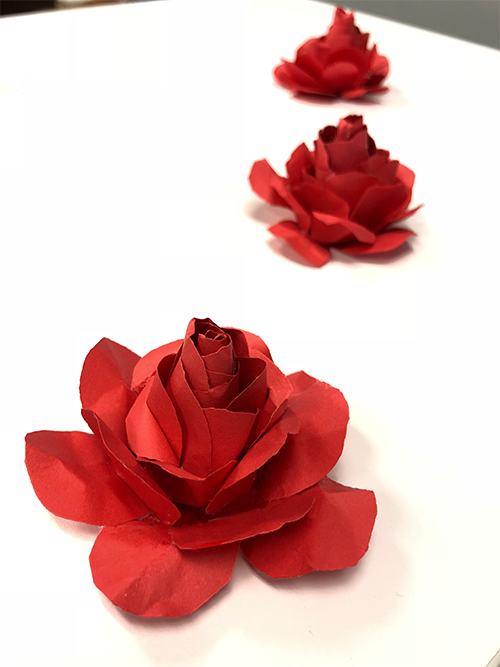 line of red roses made from paper