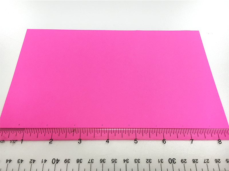 Pink paper folded, clear ruler