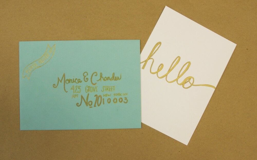 Blue envelope, white "hello" card