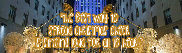 white and gold christmas decorations between skyscrapers with gold text