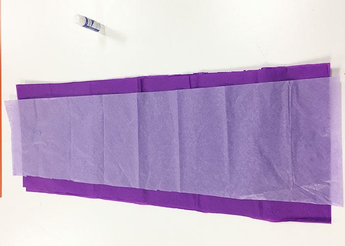 Thinner layer of white tissue paper placed on top of purple strip