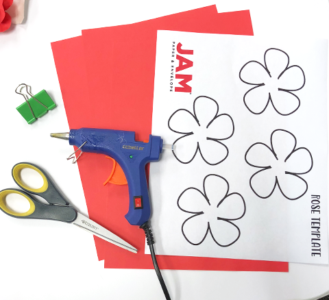 craft materials: red paper, scissors, rose template, hot glue gun, binder clip