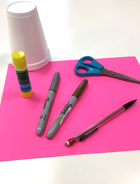 materials for drink umbrellas white styrofoam cup, markers, scissors, glue stick, and pencil on hot pink paper