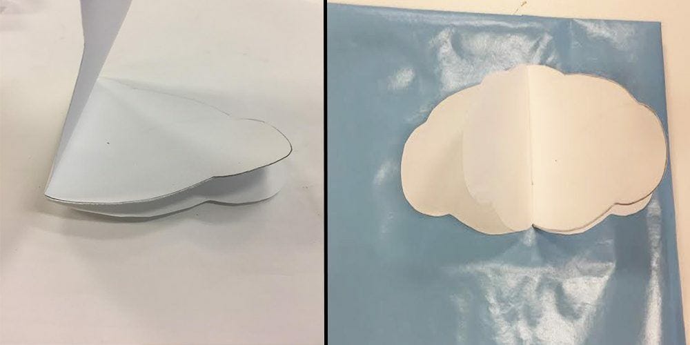 glue white cloud shapes to blue wrapping paper