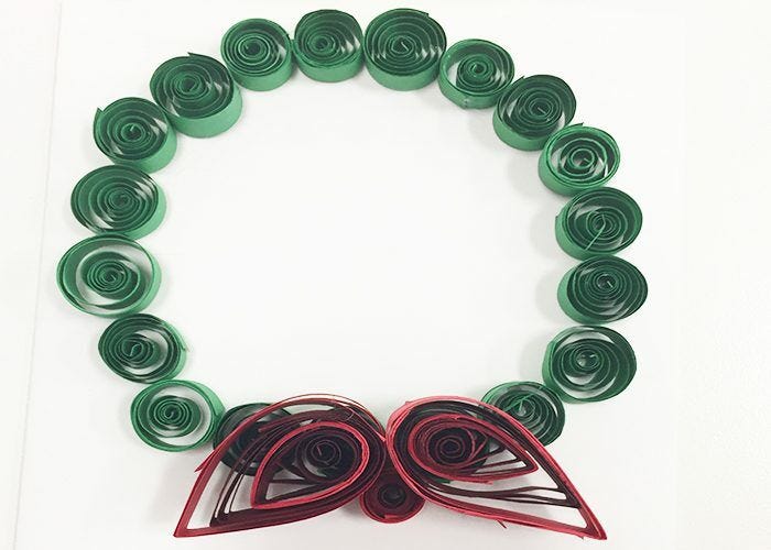 Red teardrops attached to green spiral circle